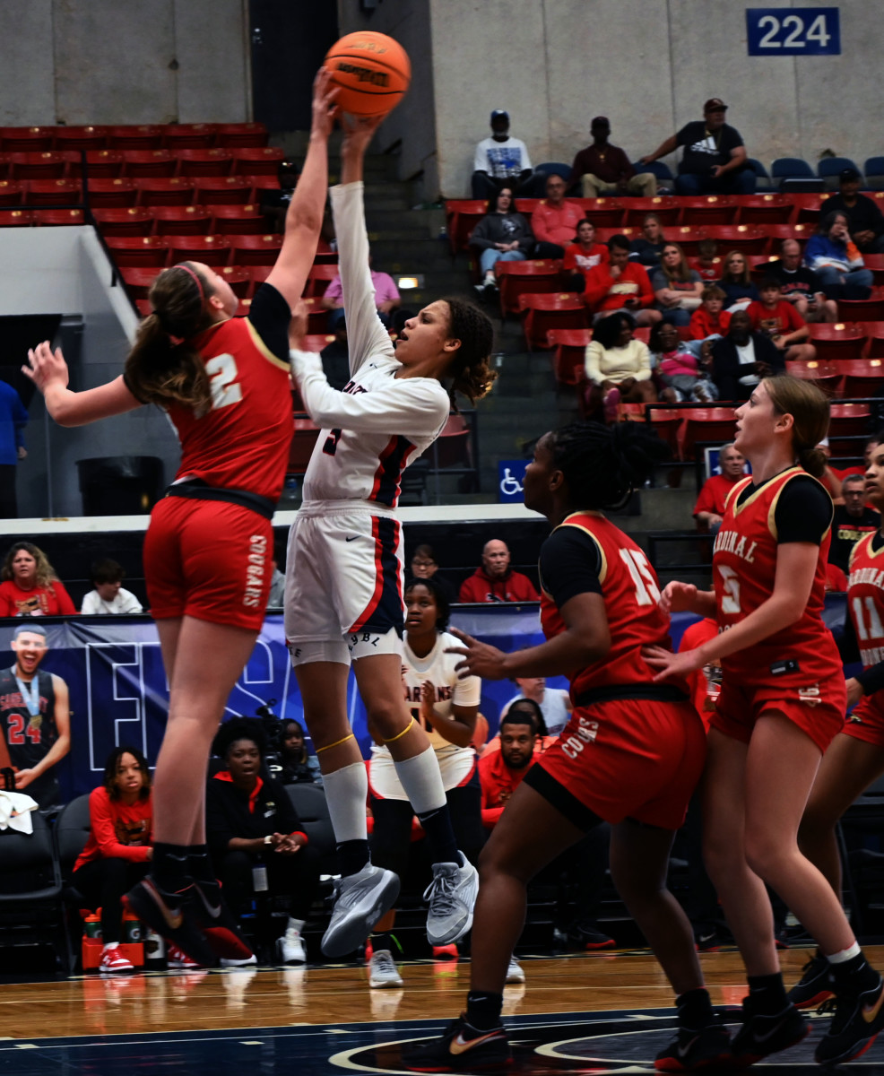 Miami Country Day guard Kaliyah Morales has her shot blocked by Cardinal Mooney’s Sam Kotasek during the Class 3A state championship at the RP Funding Center in Lakeland on Friday